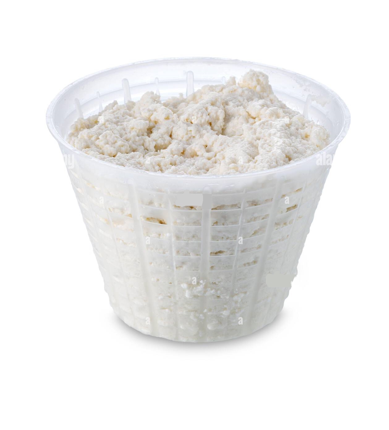 fresh ricotta in plastic basket called in italy fuscella cottage cheese in plastic bag isolated on white with clipping path 2PKKPJ4